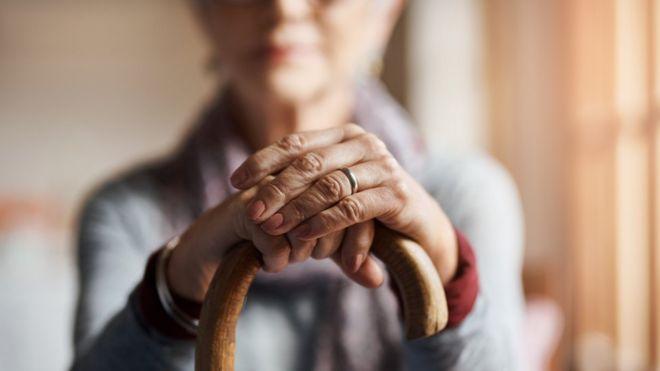 Woman holding a walking stick