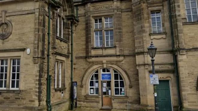 Victorian library building in brown stone with narrow windows