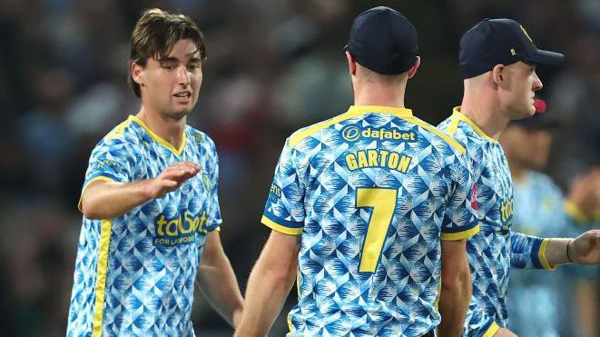 Zak Foulkes (left) celebrates one of his three Gloucestershire wickets at Edgbaston