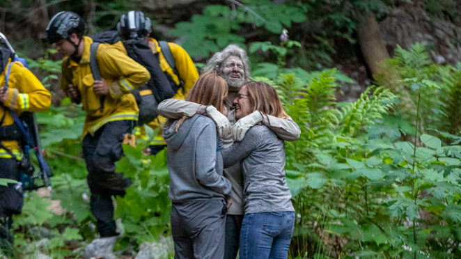 Photo of missing hiker hugging his family after he was found