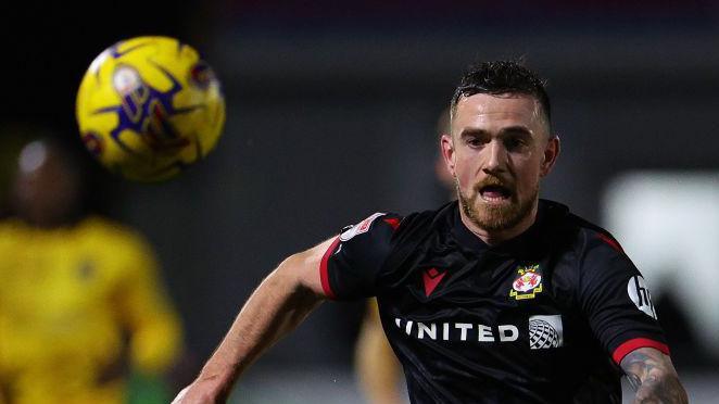 Jack Marriott chases the ball during a match for Wrexham