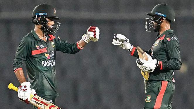 Bangladesh's Towhid Hridoy (L) and captain Mehidy Hasan Miraz (C) celebrate their team's win at the end of the second one-day international (ODI) cricket match between Bangladesh and Australia at the Sher-e-Bangla National Stadium in Dhaka 