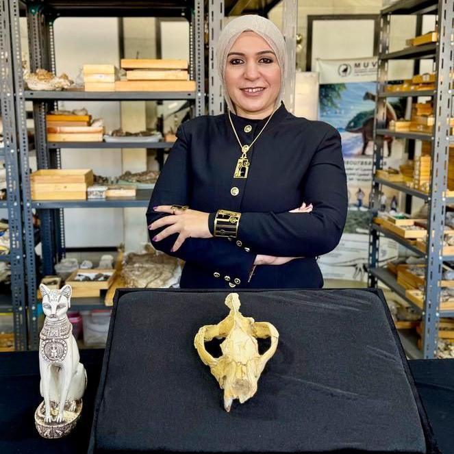 Shorouq Al-Ashqar, the lead author, with the Bastetodon syrtos skull and a Bastet statue.