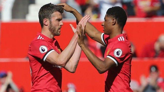Marcus Rashford (right) with Michael Carrick