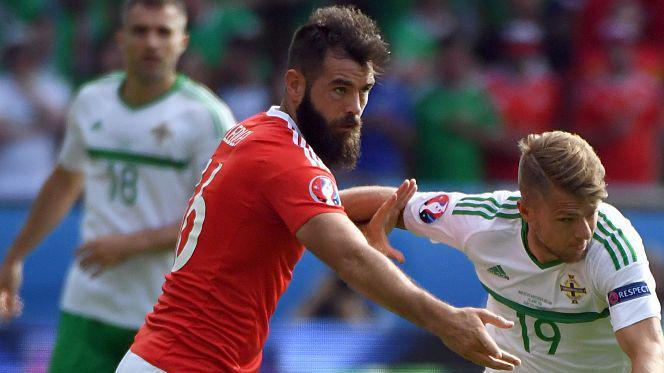 Joe Ledley of Wales competes for the ball with Jamie Ward of Northern Ireland 