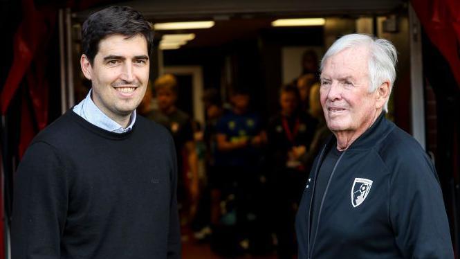 Bournemouth head coach Andoni Iraola chats with club owner and chairman Bill Foley