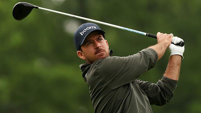 Nick Taylor drives off the tee with a wood