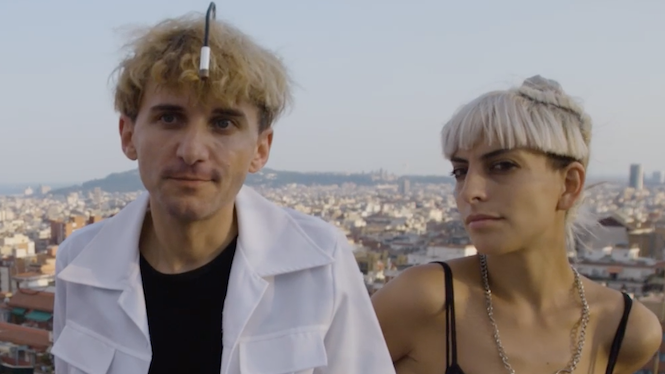 Neil Harbisson in a white shirt and Moon Ribas in a black vest top, on a Barcelona rooftop