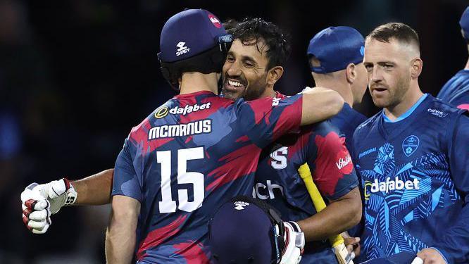 Ravi Bopara and Lewis McManus embrace