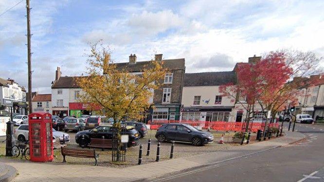 Google street view of cars parked in the town's historic market square