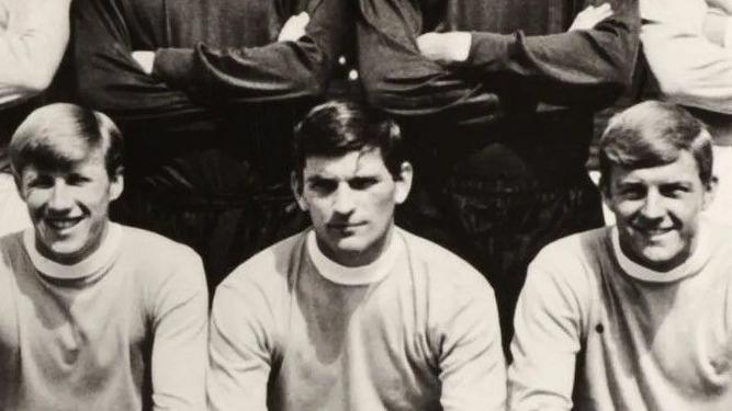 A black and white team photograph showing Jobby Crossan (centre) - pictured with Colin Bell (left) and Chris Jones (right) - captained Manchester City.