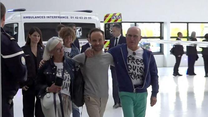 French citizen Louis Arnaud flanked by his mother and father upon arrival at Le Bourget airport, north of Pari