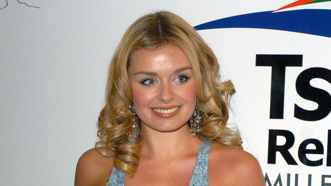 Katherine Jenkins pictured in 2005 before the Tsunami relief concert wearing a blue dress with curly blonde hair