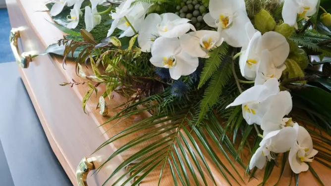 White flowers on a wooden coffin