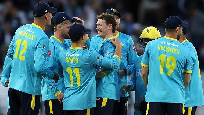 Rob Yates is congratulated by his Bears teammates after taking a wicket at Notts Outlaws