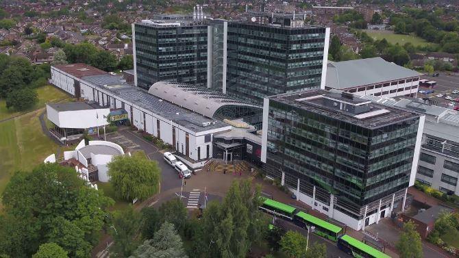A drone view of the university. It is a series of multi-storey buildings with large clear glass windows