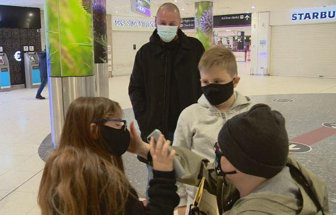 Jill is greeted by her family at Edinburgh Airport