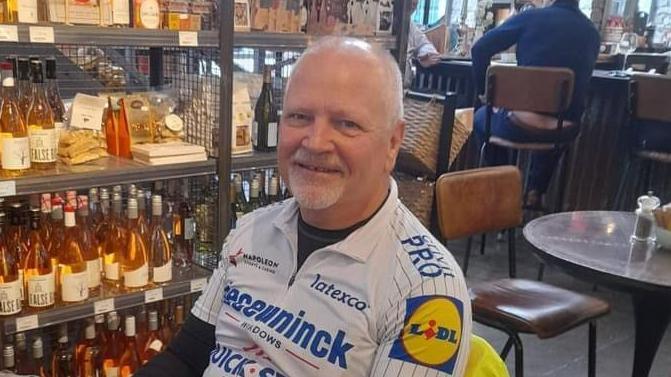 Eric Oakley wearing cycling gear, sitting in a bar