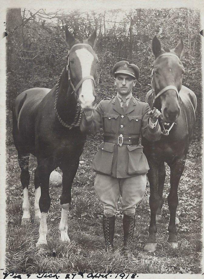 A picture taken in 1918 of an officer flanked by two war horses