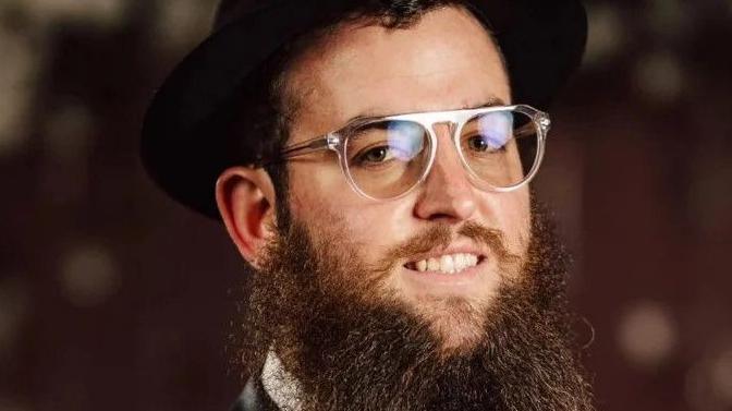 File photo showing Rabbi Zvi Kogan wearing a hat and glasses 