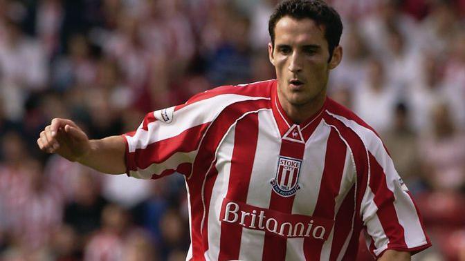 Footballer Clive Clarke controls the ball during a Stoke City match
