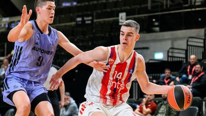 Nikola Topic dribbles with the ball and holds off a defender while in action for Crvena Zvezda