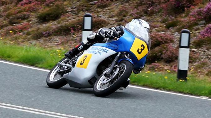 Dean Harrison on a blue and silver machine with the number three on the front and side.