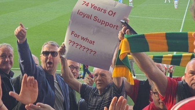 Manchester United supporter Michael Carney (centre) protesting during the 0-0 draw with Manchester City in April