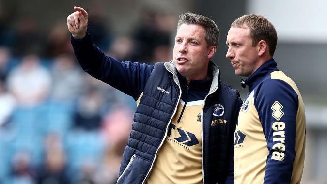 Neil Harris (left) and David Livermore on the touchline while managing Millwall in 2017