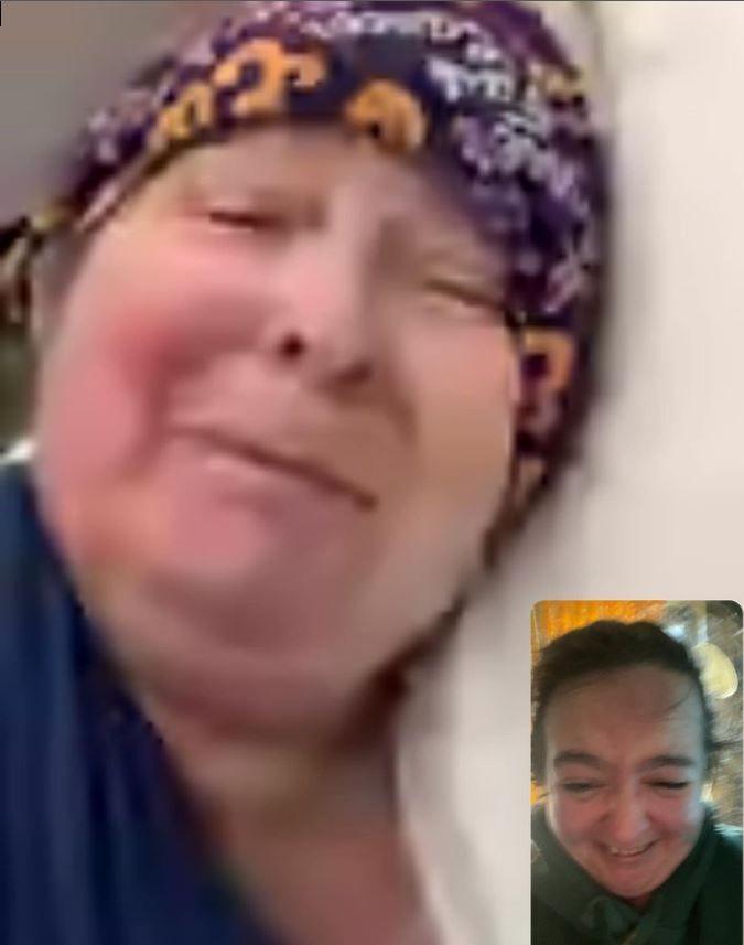 Janey Godley on a Facetime grab. Janey is in her hospital bed with a scarf around her head. Her daughter is in an inset box looking tearful