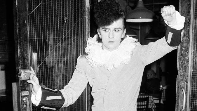 A black-and-white image of Steve Strange at the Blitz club, dressed in a ruffled outfit