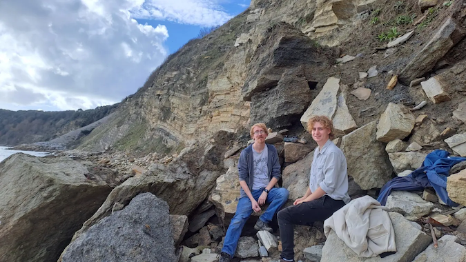 Dr Roy Smith and University of Portsmouth student Ben Weston by the flint bed in Durlston Bay near Swanage, which is the layer of rock the mammal fossil came out of.