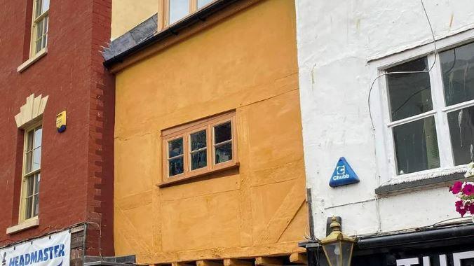 A yellow painted timber building on Westgate Street in Gloucester