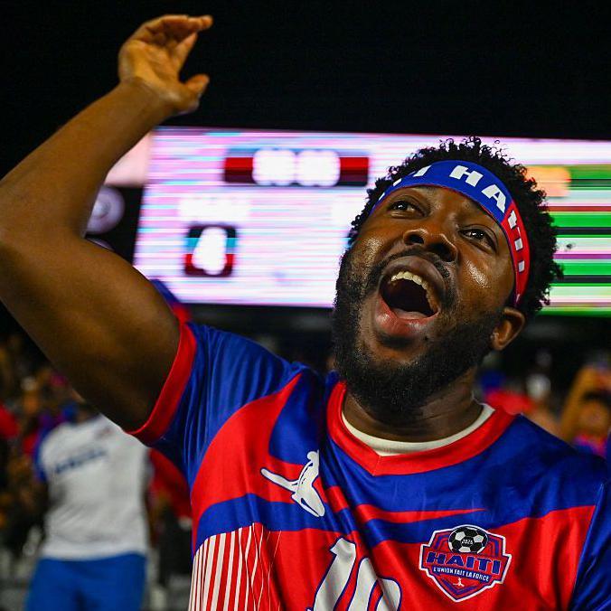 A Haiti fan celebrates during a World Cup warm-up match
