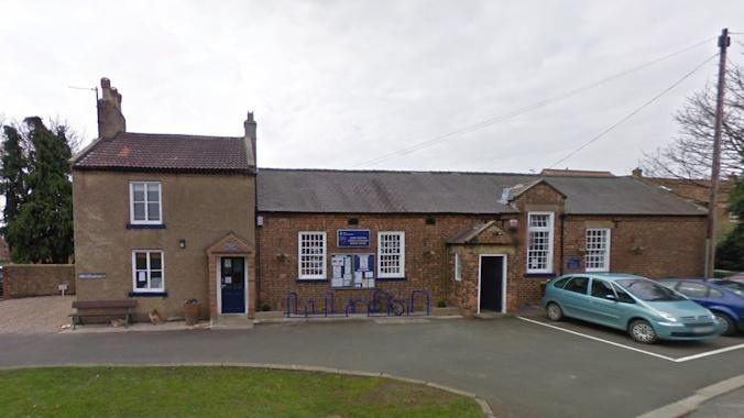 A screenshot from Google of a brown brick school building. 