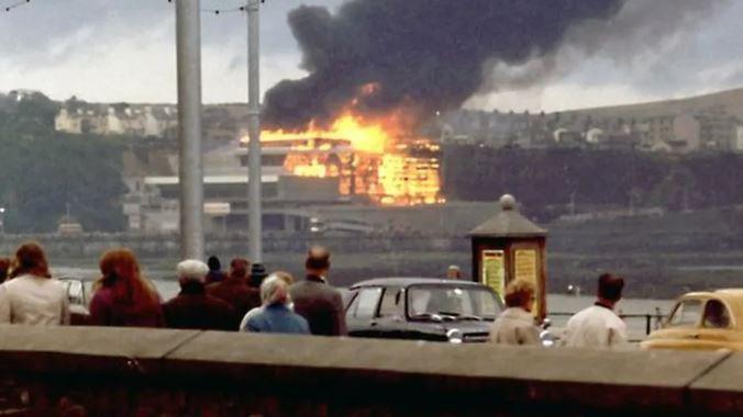 Archive picture of people looking on at the complex on fire