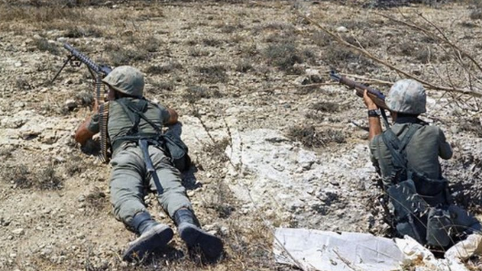 Two men on the group in a stony environment