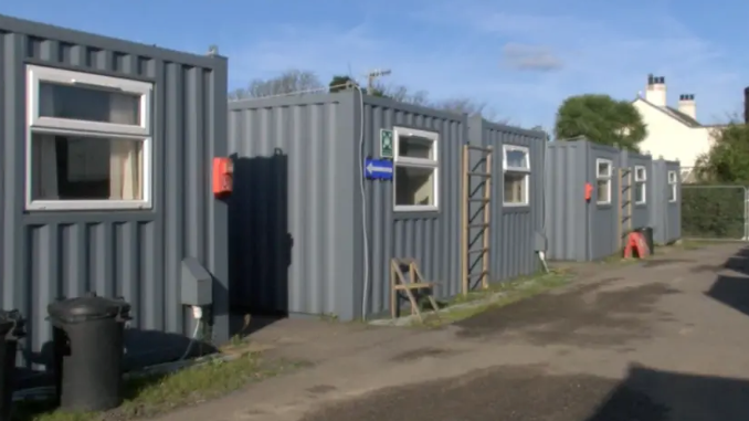 Four corrugated iron crates. 