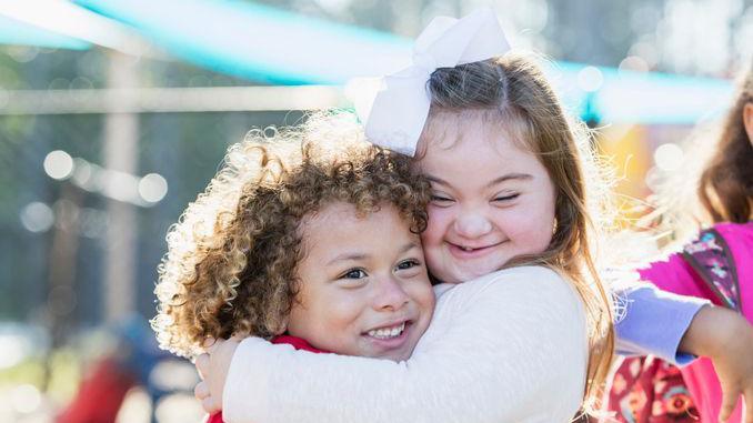 Two friends hugging each other.