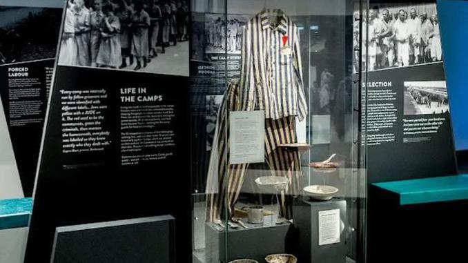 An exhibition cabinet displaying concentration camp detainees clothing