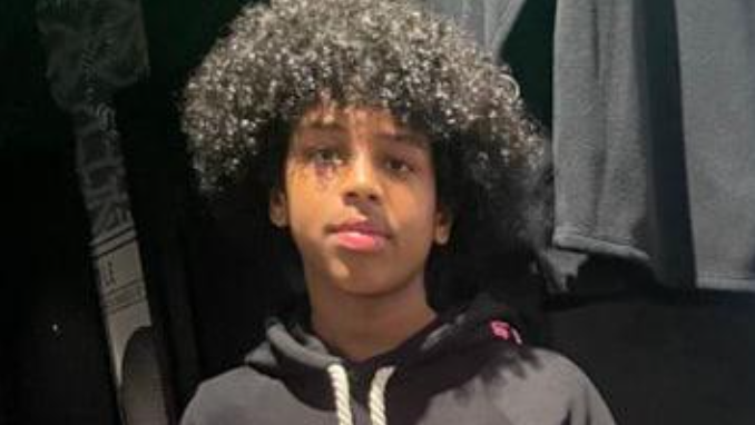 Mohanad Abdullaahi Goobe. He had short curly hair and is wearing a dark hoodie.