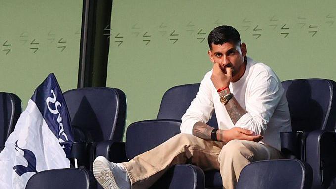 Cristian Romero of Tottenham Hotspur watches from the stands 