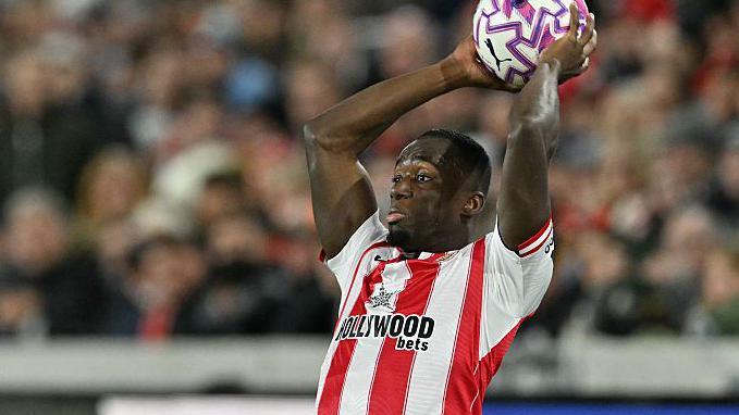 Michael Kayode takes a throw-in for Brentford