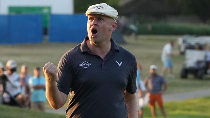 Golfer Harry Hall celebrates his win