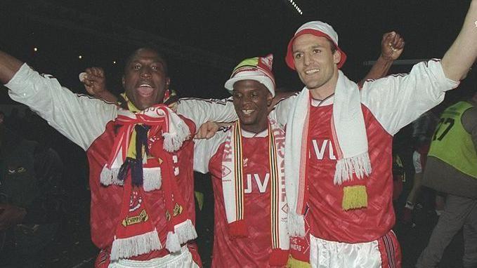 Kevin Campbell (left) celebrates Arsenal's 1991 title win with Paul Davis and Steve Bould