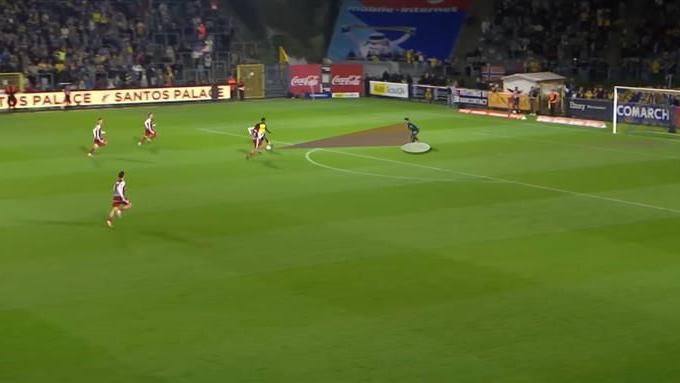A screengrab from a match in which goalkeeper Senne Lammens has come off his line to the middle of his penalty box holding his position well in a one against one situation with the opposition striker attacking the goal. 