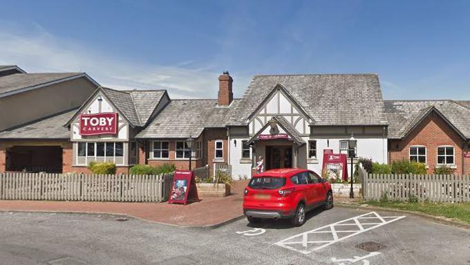 A general view of the Toby Carvery branch in Billingham. It has black and white Tudor-style cladding. A red car is parked outside in a disabled bay.