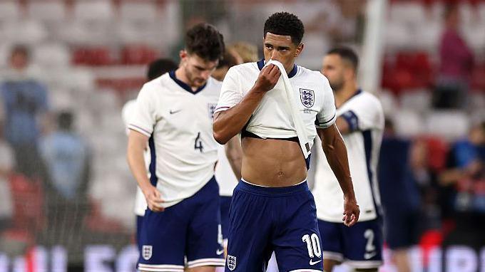 Jude Bellingham wipes his face with his shirt after England's 3-1 defeat by Senegal