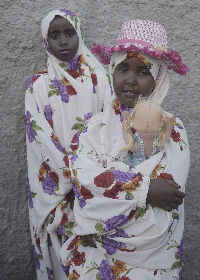 Girls holding dolls