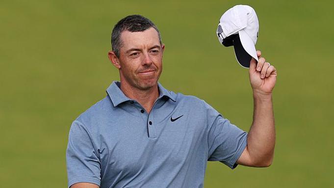 Rory McIlroy acknowledges the crowd while walking to the final green on Sunday